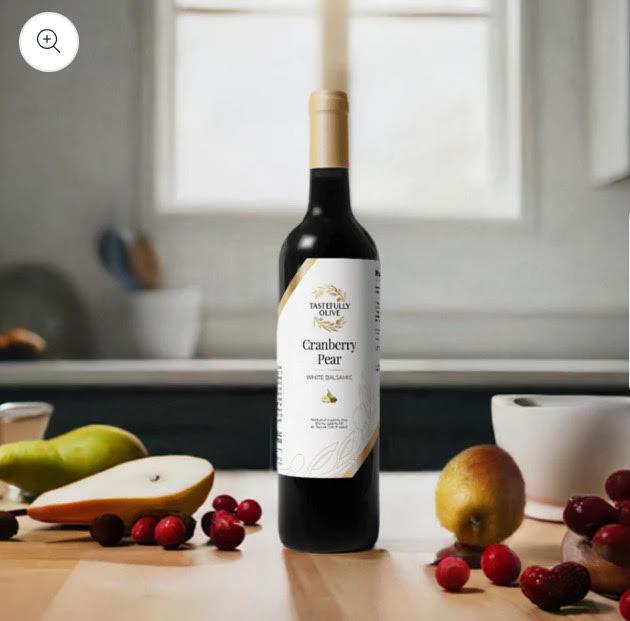 Cranberry Pear white balsamic vinegar bottle with fresh cranberries and pears on kitchen counter