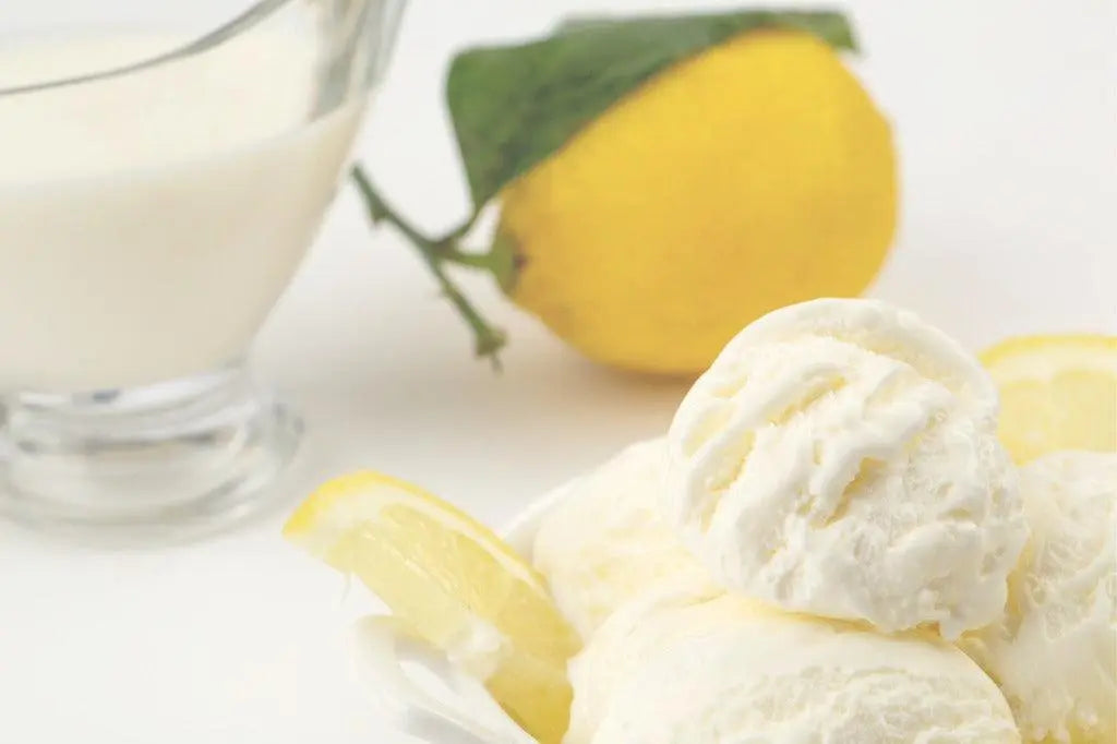 Creamy lemon ice cream scoops with fresh lemon slices and a glass of milk, perfect for dessert