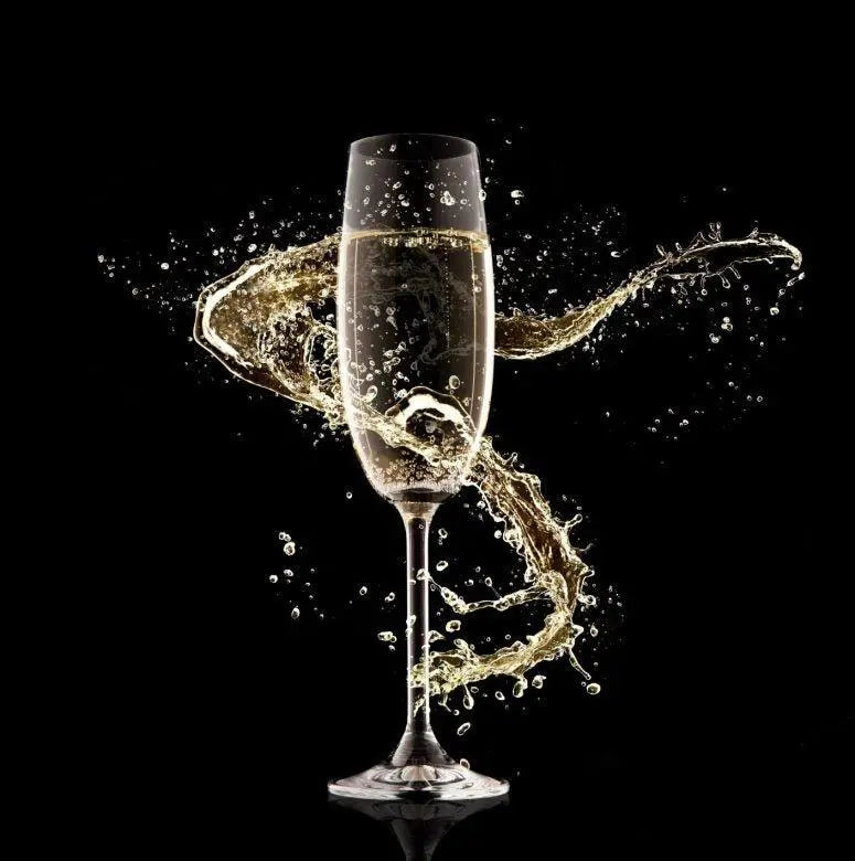 Golden champagne splashing from flute glass against black background