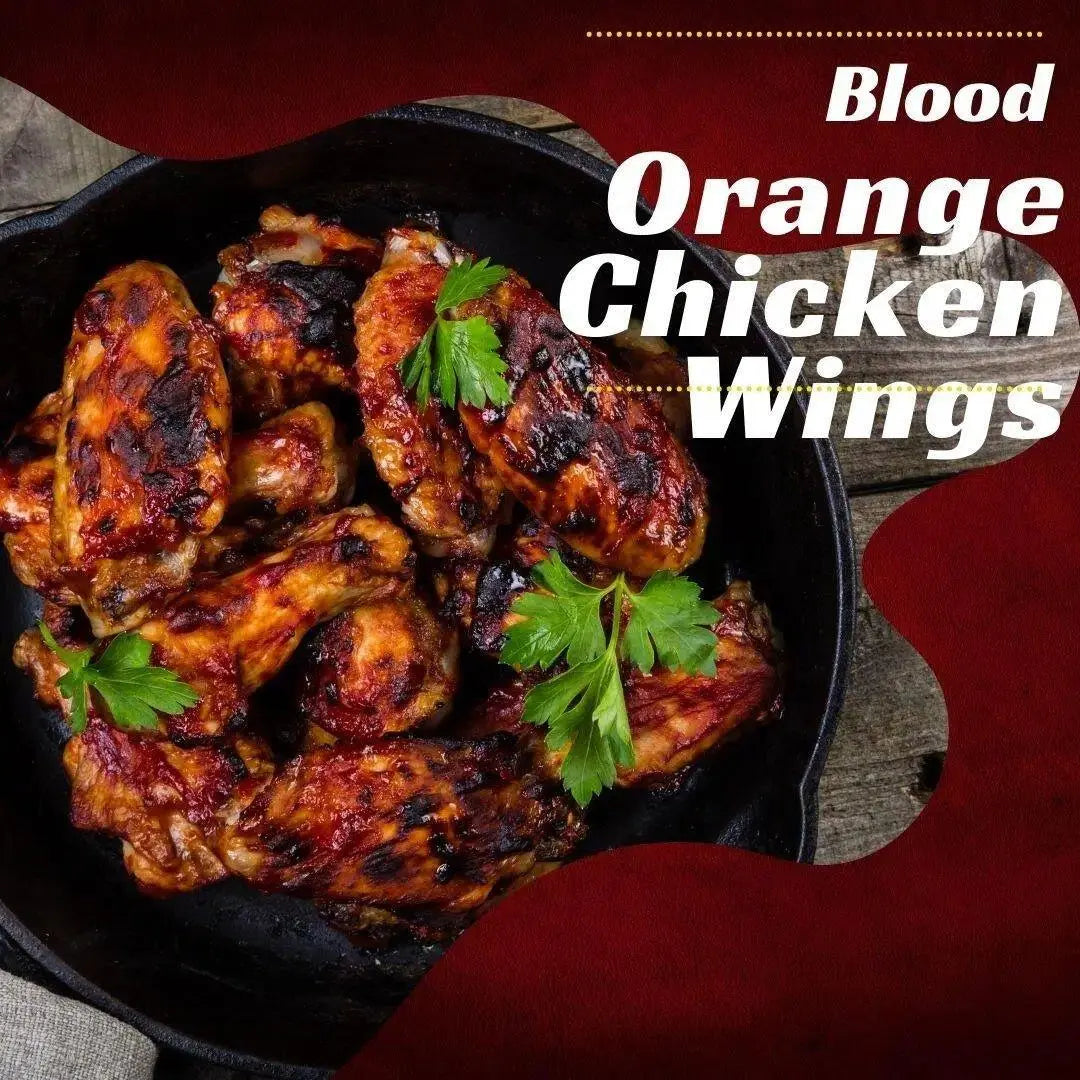 Blood Orange Chicken Wings in cast iron skillet with fresh parsley garnish